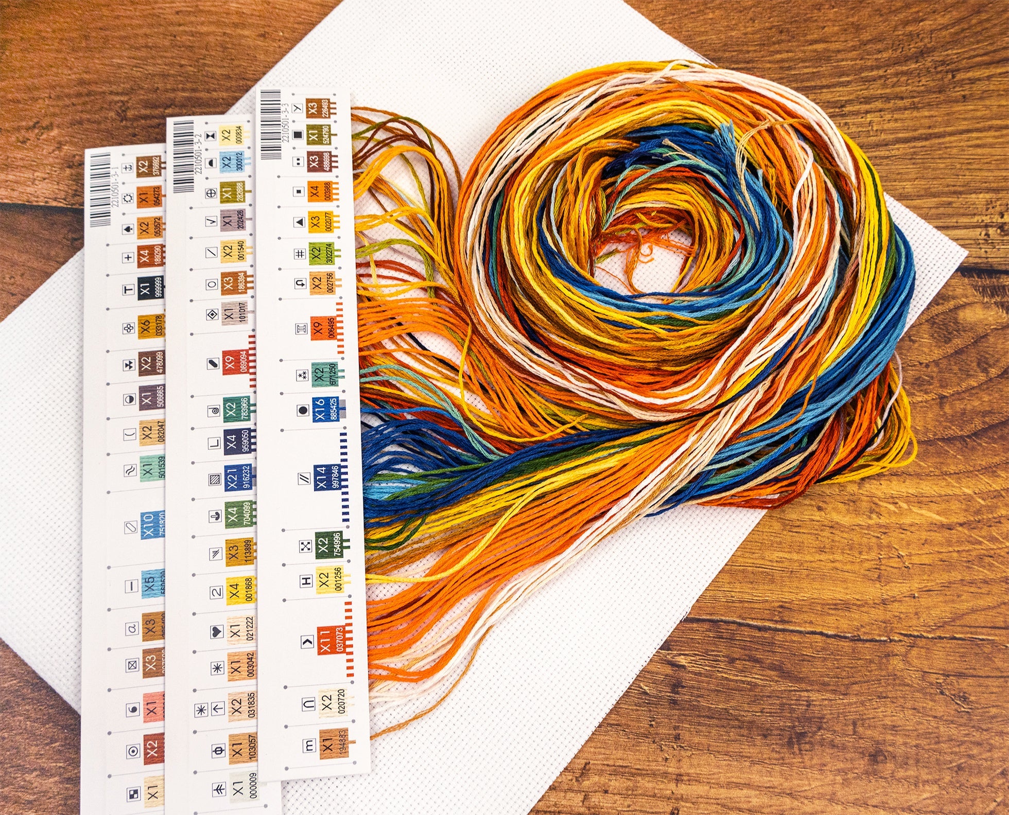 Color swatch book with yarn on a wooden surface