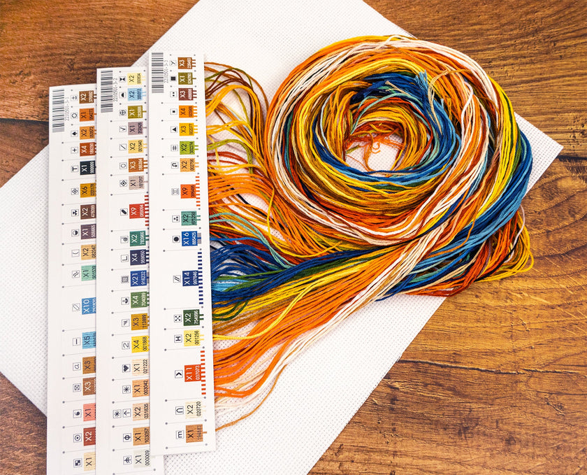 Color swatch book with yarn on a wooden surface