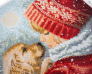 Close-up of a beaded artwork depicting two dogs in winter clothing with snowflakes in the background.