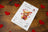 Cross-stitch kit for a teddy bear with hearts on a wooden surface