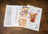 Cross-stitch kit with pattern, color chart, and teddy bear design on a wooden surface