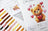 Cross stitch kit with a teddy bear design and color swatch on a white background