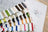 Color swatch card with thread samples on a wooden surface