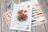 Cross stitch kit with poppy flowers design on a wooden surface