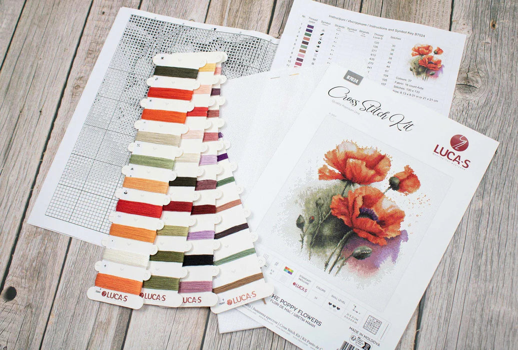 Color swatch and painting of poppies on a wooden surface
