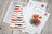 Color swatch and painting of poppies on a wooden surface