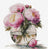Cross-stitched design of pink flowers in a vase on a white background