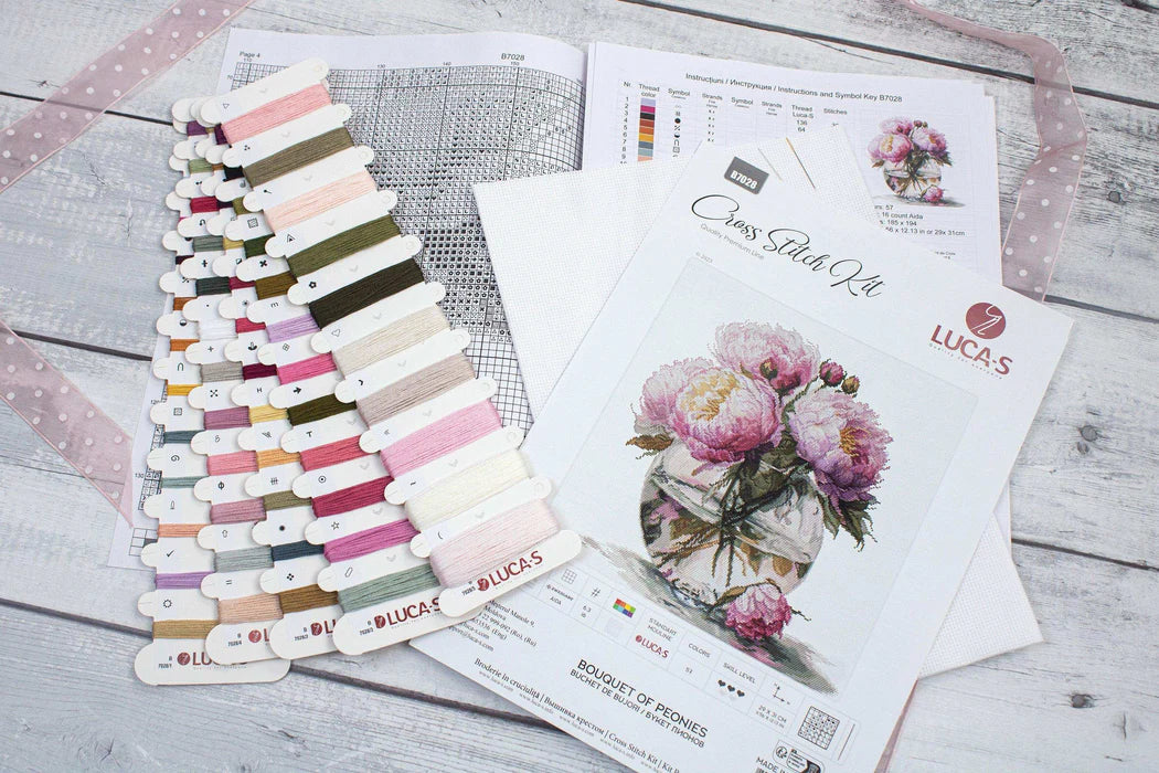 Color swatch card with fabric samples and a floral design on a white surface