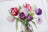 Cross-stitched design of tulips in a jar on fabric