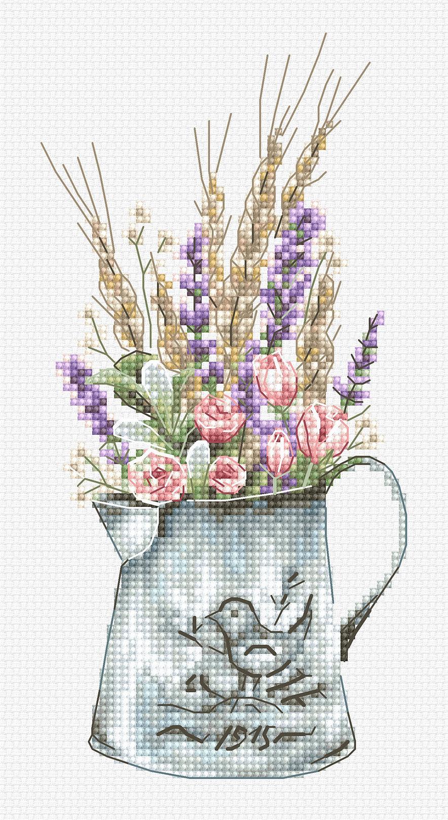 Cross-stitched design of a pitcher with flowers and a bird illustration on a white background