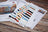 Color swatches and cross stitch pattern on a wooden surface