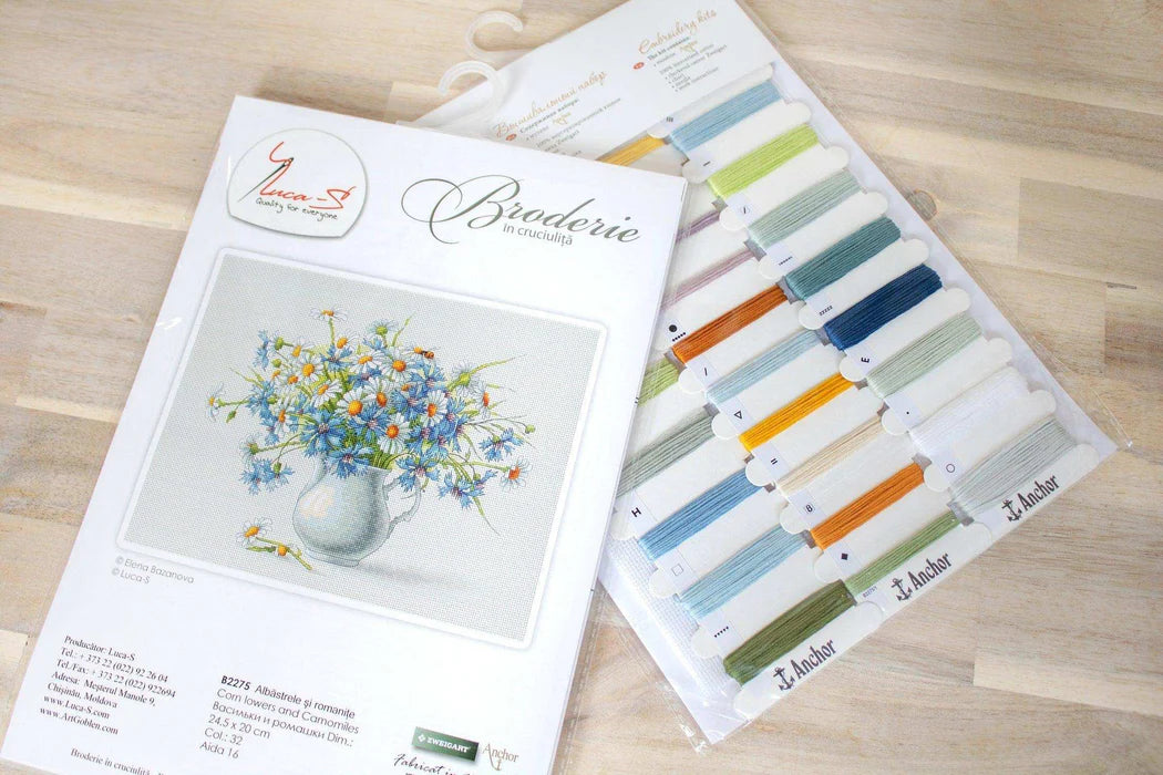 Design kit with color swatches and floral illustration on a wooden surface