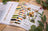Lucas embroidery thread set with color chart and forest animals design on a wooden surface.