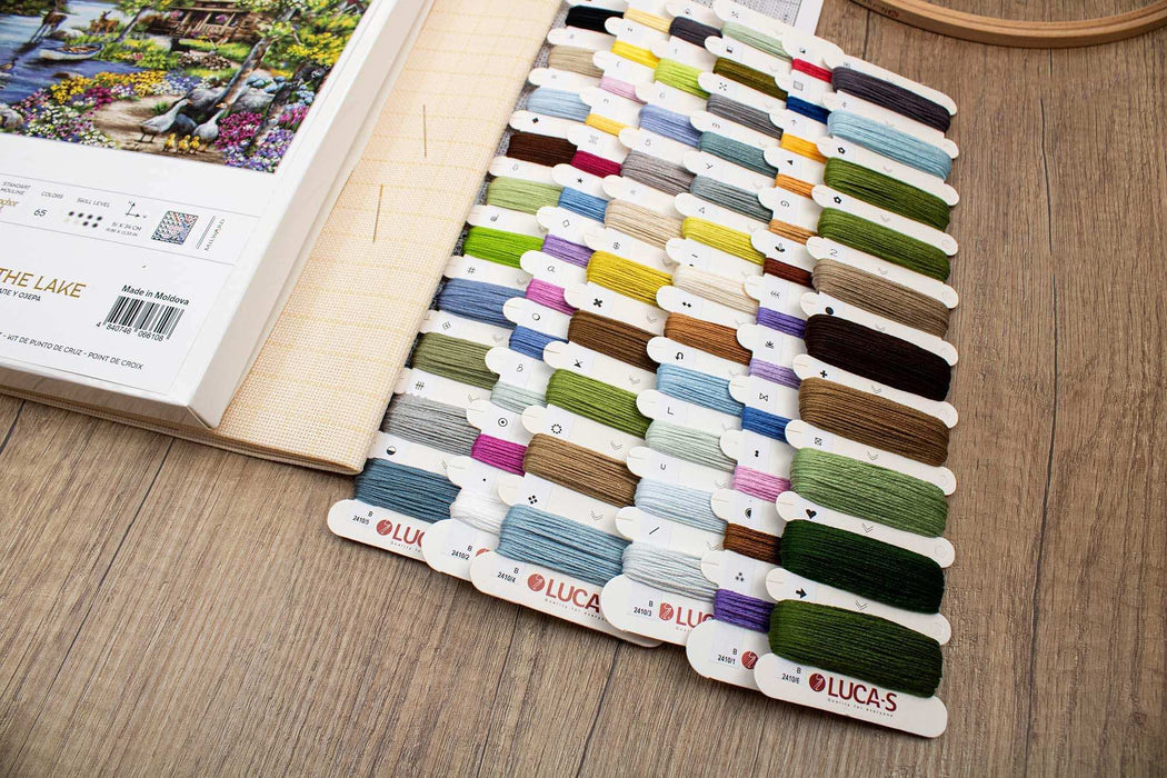 Color swatch book with embroidery threads on a wooden surface