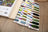 Color swatch book with embroidery threads on a wooden surface