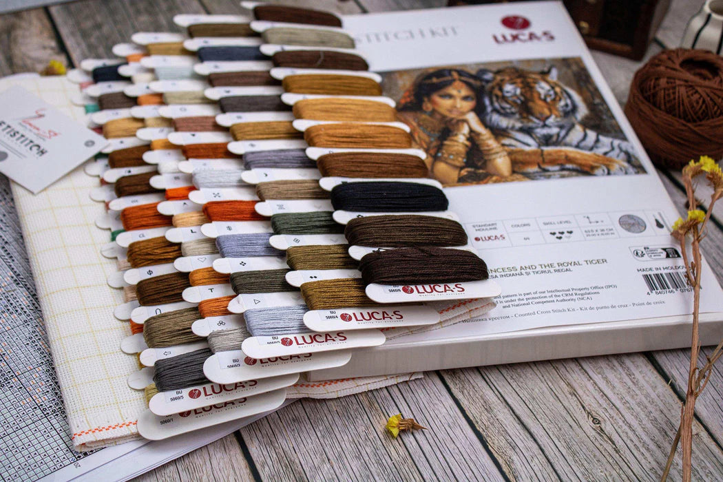 Color swatch book with embroidery thread colors on a wooden surface