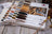 Lucas embroidery floss color chart with a tiger and woman illustration on a wooden surface.