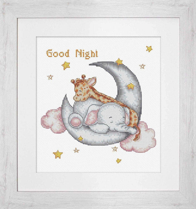 Framed cross-stitch art of a lion and elephant sleeping on a moon with 'Good Night' text.