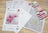 Cross stitch kit with pattern, color chart, and fabric on a wooden surface
