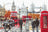 London scene with red double-decker bus, black taxi, and red phone box.