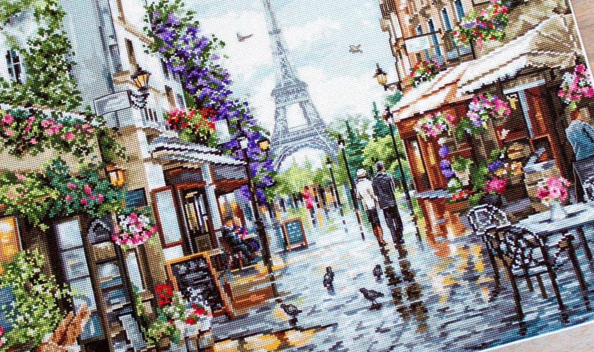 Cross-stitched city scene with Eiffel Tower and street details