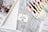 Collection of embroidery threads and a pattern book on a wooden surface