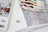 Thread spools and embroidery pattern on a wooden surface