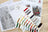 Cross stitch kit with thread samples and pattern on a wooden surface