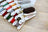 Set of embroidery threads on cards with 'Lucas' branding on a wooden surface