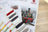 Cross stitch kit with color swatches and train design on a wooden surface