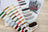 Color swatch card with embroidery threads on a wooden surface