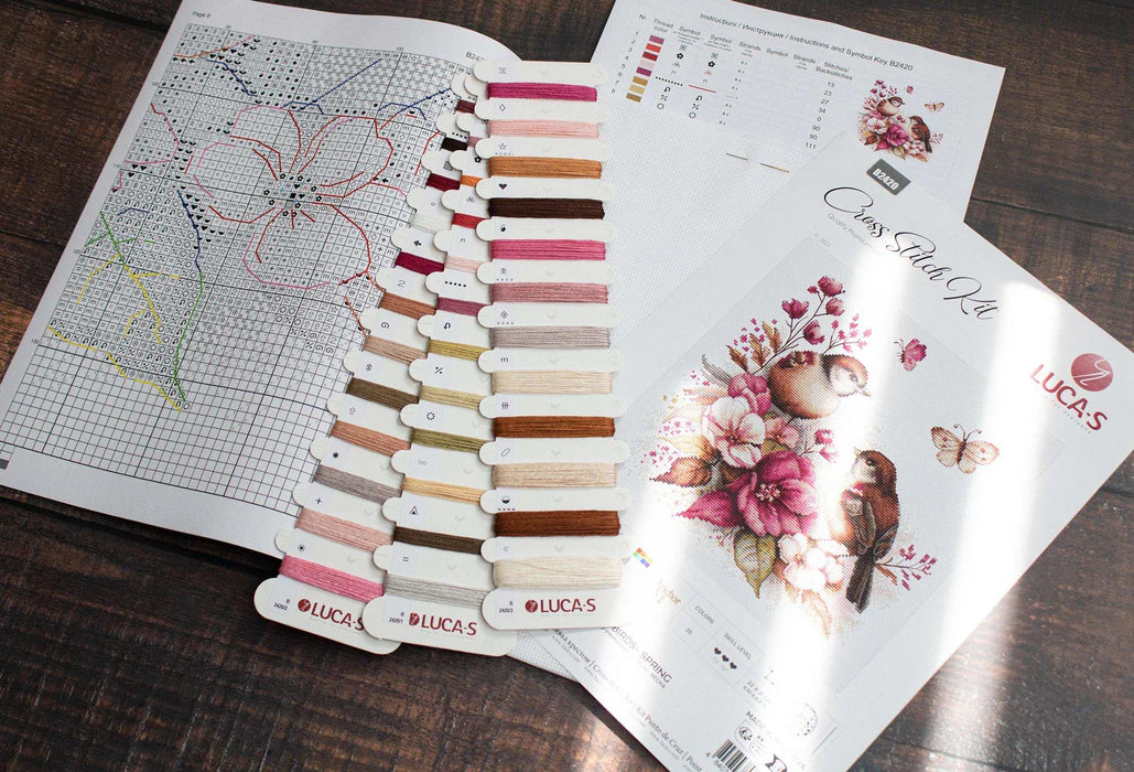 Embroidery kit with color chart and pattern on a wooden surface
