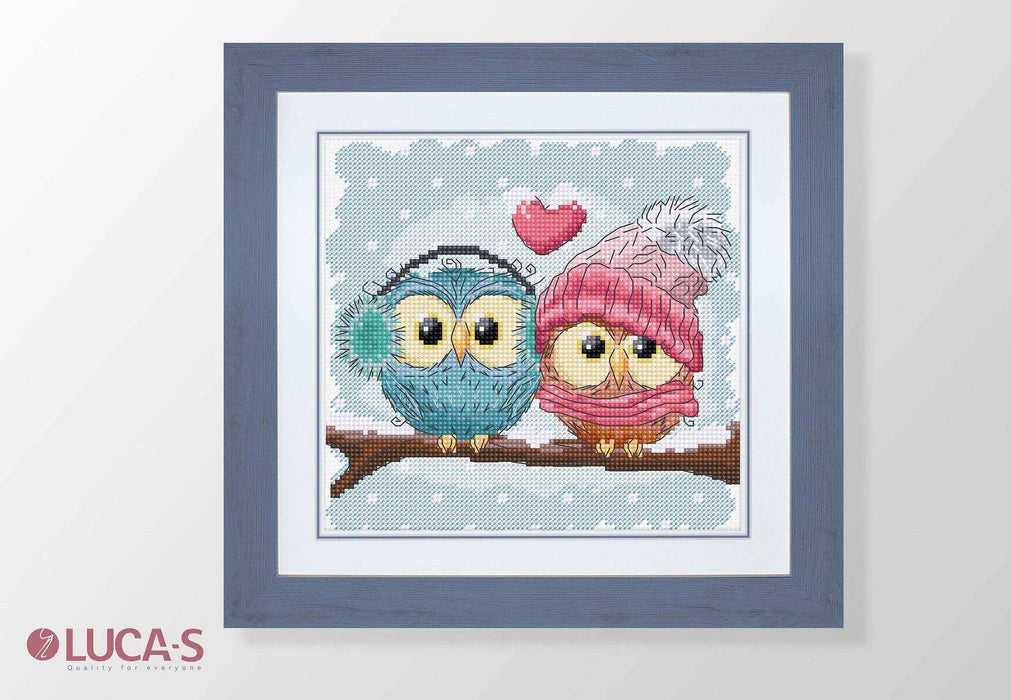 Cross-stitched design of two owls in love with a heart, framed by Luca-S brand.